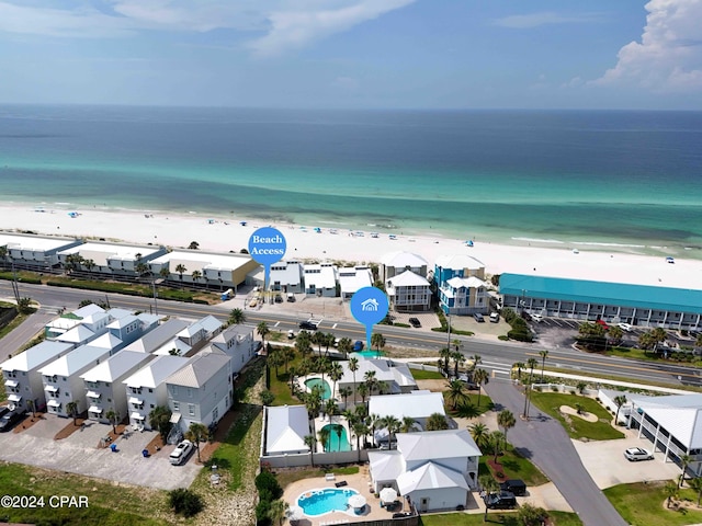 drone / aerial view featuring a water view and a beach view