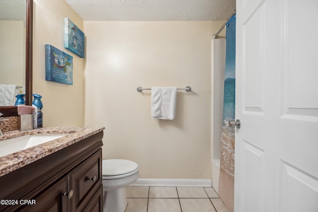 full bathroom featuring vanity, tile patterned flooring, toilet, and a textured ceiling