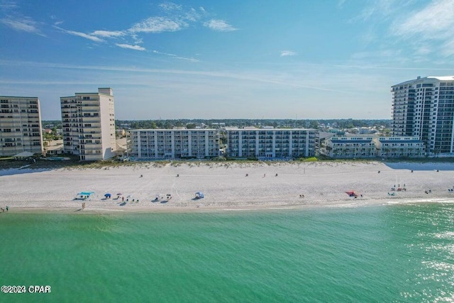 birds eye view of property with a view of the beach and a water view