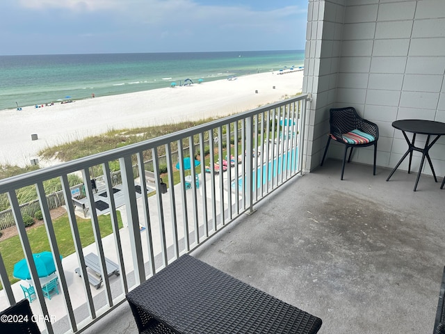 balcony with a water view and a beach view