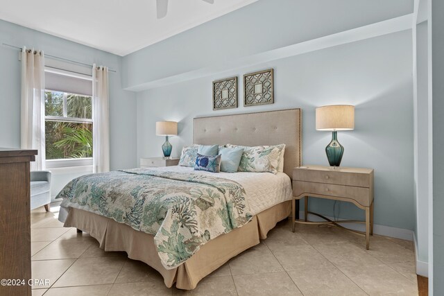 tiled bedroom featuring ceiling fan