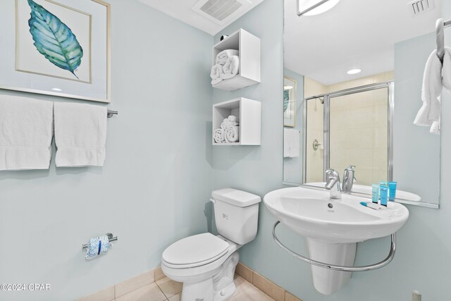 bathroom with toilet and tile patterned floors