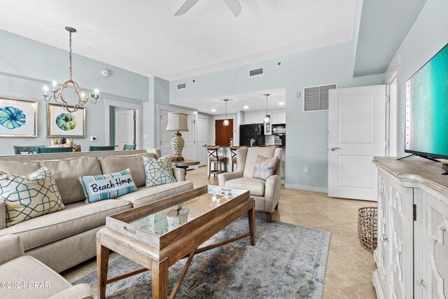 living room with ceiling fan with notable chandelier and light tile patterned flooring