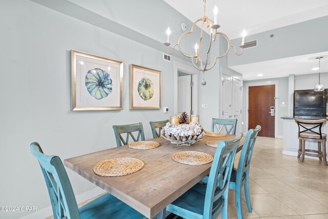 tiled dining area with an inviting chandelier