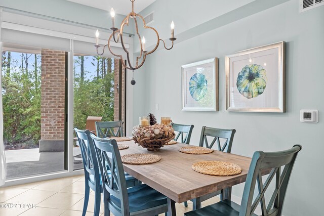 dining area with light tile patterned floors and a chandelier