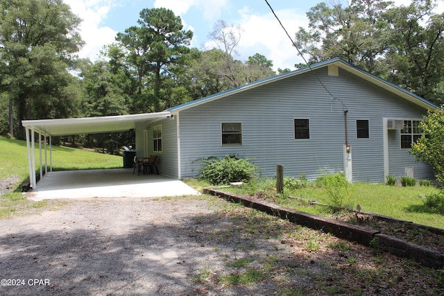 view of home's exterior featuring a lawn and a carport