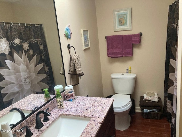 bathroom featuring vanity, hardwood / wood-style flooring, and toilet