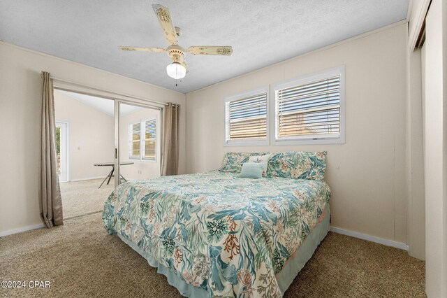 carpeted bedroom with a textured ceiling and ceiling fan