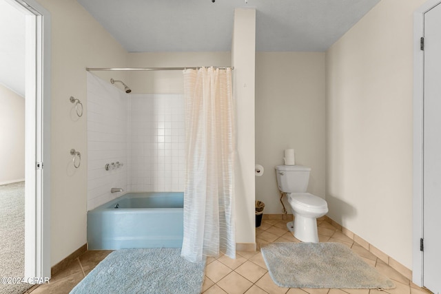 bathroom with shower / tub combo, tile patterned flooring, and toilet