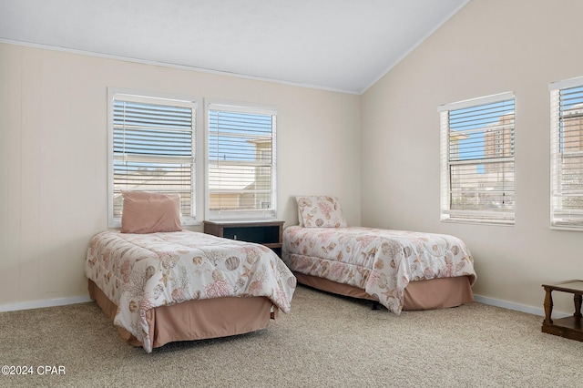 bedroom with crown molding, light carpet, and vaulted ceiling