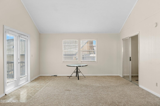 empty room featuring lofted ceiling and light colored carpet