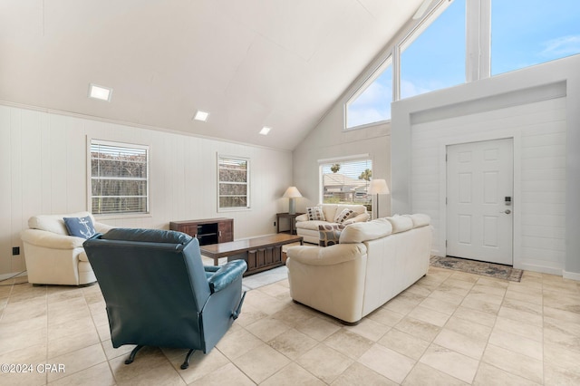 living room with light tile patterned flooring and high vaulted ceiling