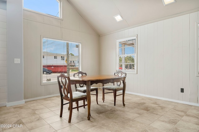 dining area featuring light tile patterned floors and high vaulted ceiling