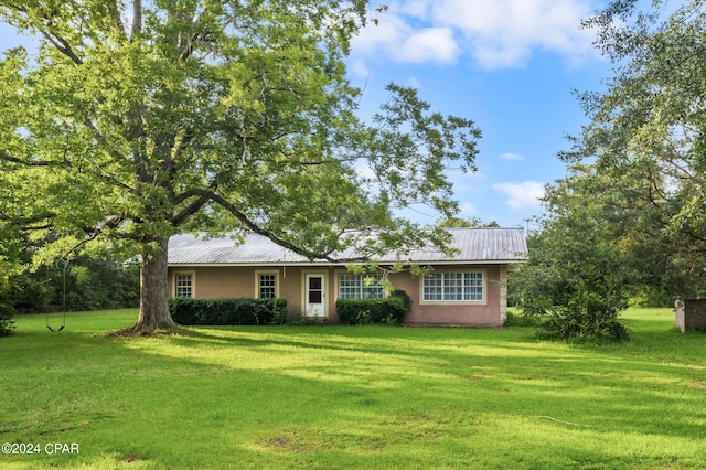 ranch-style home with a front lawn