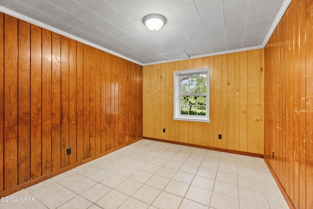 spare room with wooden walls and crown molding