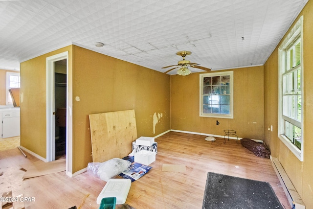 unfurnished room featuring ceiling fan, light hardwood / wood-style flooring, and a baseboard heating unit