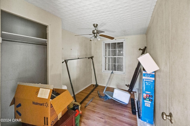 interior space with wood-type flooring and ceiling fan