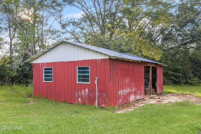 view of outbuilding featuring a yard