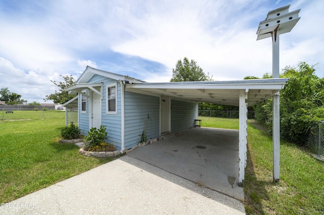 view of vehicle parking featuring a carport and a yard