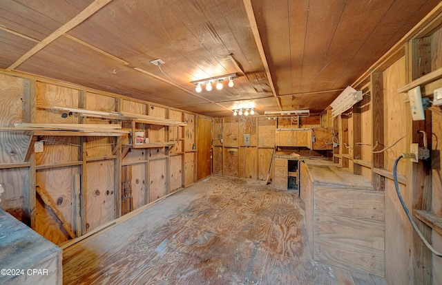 interior space featuring wooden ceiling, wooden walls, and a workshop area