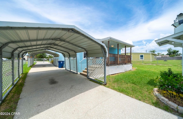 view of vehicle parking with a carport and a lawn