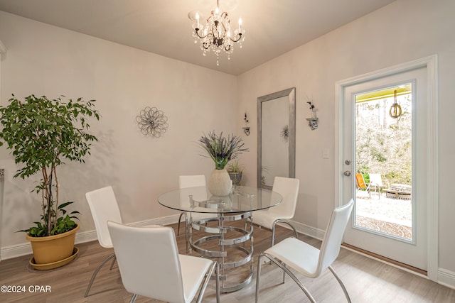 dining space with a chandelier and hardwood / wood-style flooring