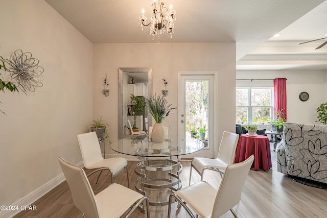 dining room featuring ceiling fan with notable chandelier and wood-type flooring