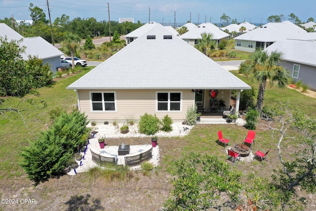 exterior space with a lawn, a fire pit, and a patio