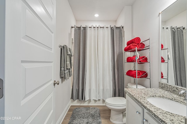 full bathroom with toilet, vanity, shower / tub combo with curtain, and hardwood / wood-style floors