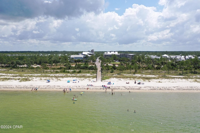 aerial view with a water view and a beach view