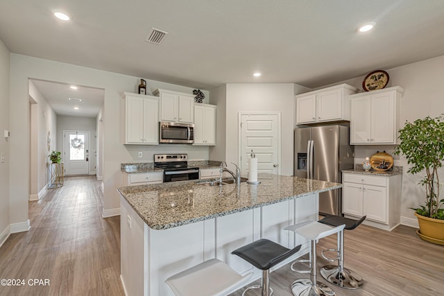 kitchen featuring sink, stainless steel appliances, and white cabinetry