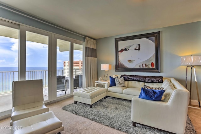 living room with a water view and light colored carpet