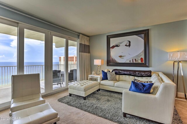 living room with a water view and light colored carpet