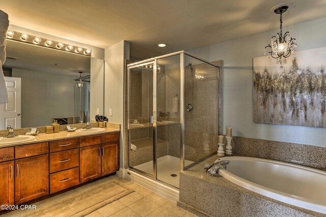 bathroom with tile patterned flooring, vanity, separate shower and tub, and a notable chandelier