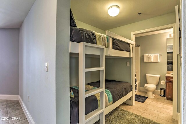 tiled bedroom with connected bathroom