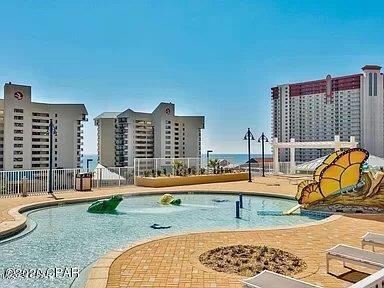 view of pool featuring a water slide and a patio area