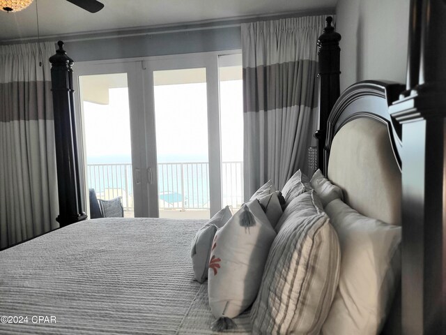 bedroom featuring access to outside and a water view