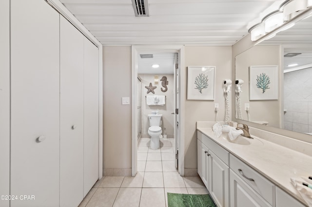 bathroom featuring tile patterned flooring, vanity, and toilet