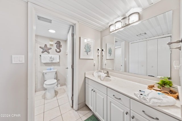 bathroom featuring vanity, tile patterned flooring, and toilet