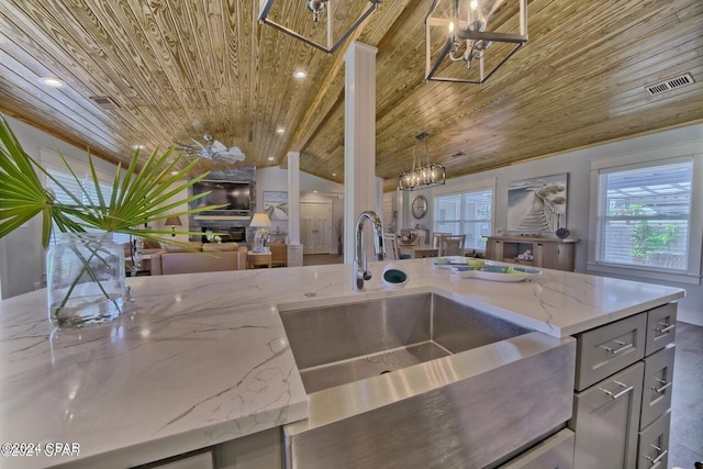 kitchen with visible vents, wooden ceiling, open floor plan, gray cabinets, and a sink