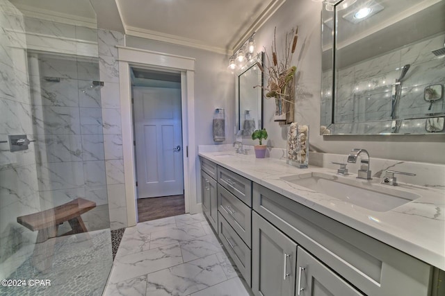 bathroom with marble finish floor, crown molding, a marble finish shower, and a sink