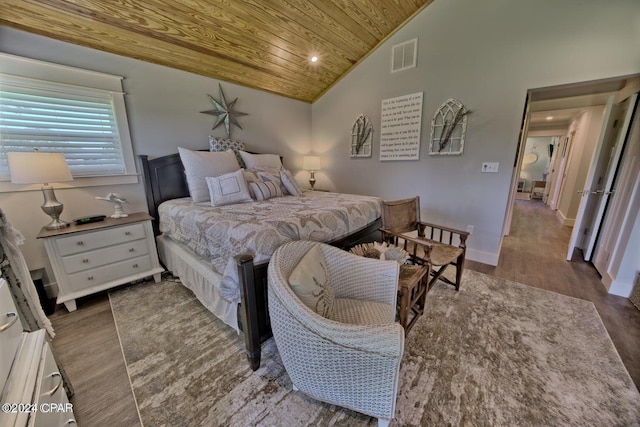 bedroom featuring visible vents, vaulted ceiling, wood finished floors, wooden ceiling, and baseboards