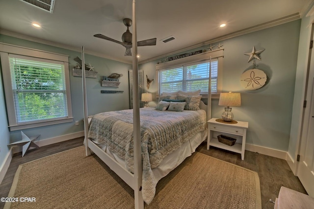 bedroom featuring ornamental molding, wood finished floors, and visible vents