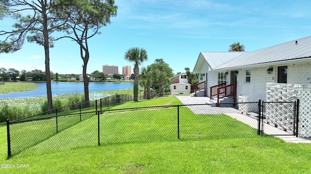 view of yard featuring a water view and fence private yard