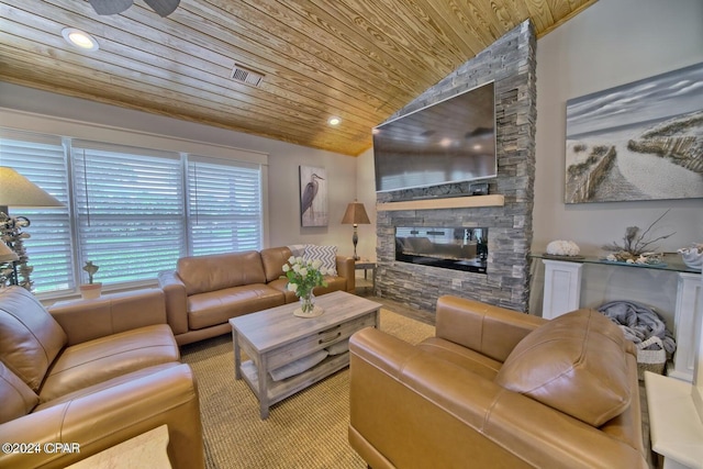 living area featuring visible vents, lofted ceiling, wooden ceiling, a stone fireplace, and recessed lighting