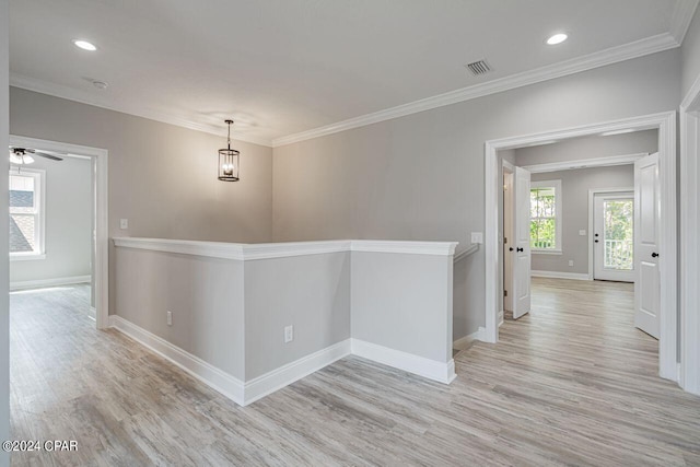 hall with ornamental molding and light wood-type flooring