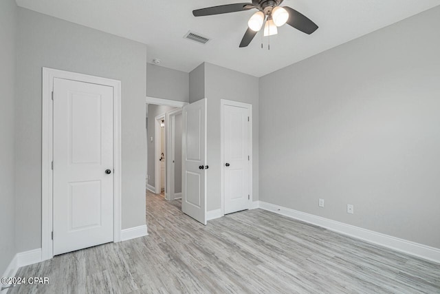 unfurnished bedroom with ceiling fan and light hardwood / wood-style flooring