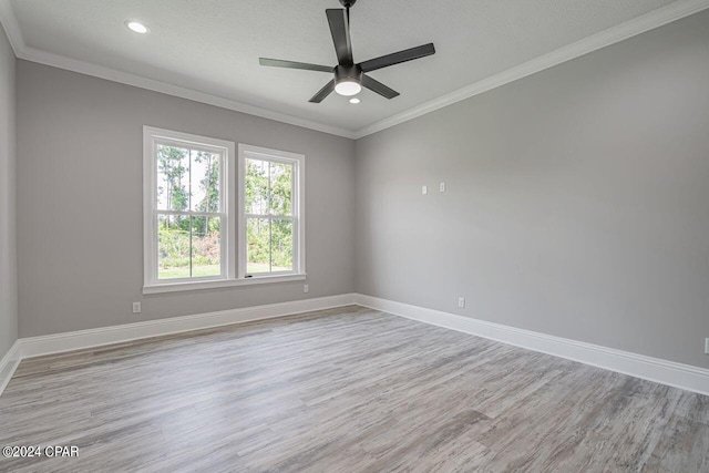 spare room with ceiling fan, ornamental molding, and light hardwood / wood-style floors