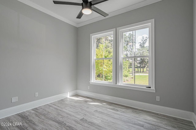 empty room with ornamental molding, ceiling fan, and light hardwood / wood-style floors