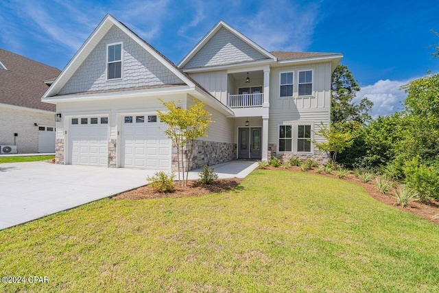 view of front of home with a balcony, a garage, and a front lawn